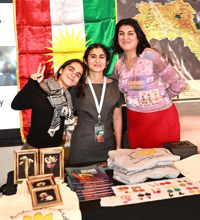 three women welcoming visitors to film festival.