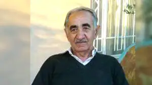 Older man in a brown sweater